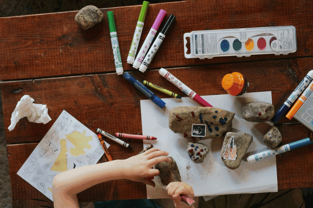 A child colouring rocks