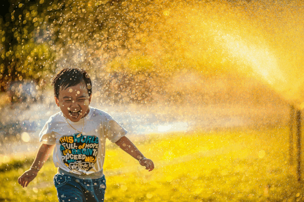 A child running through a spray of water