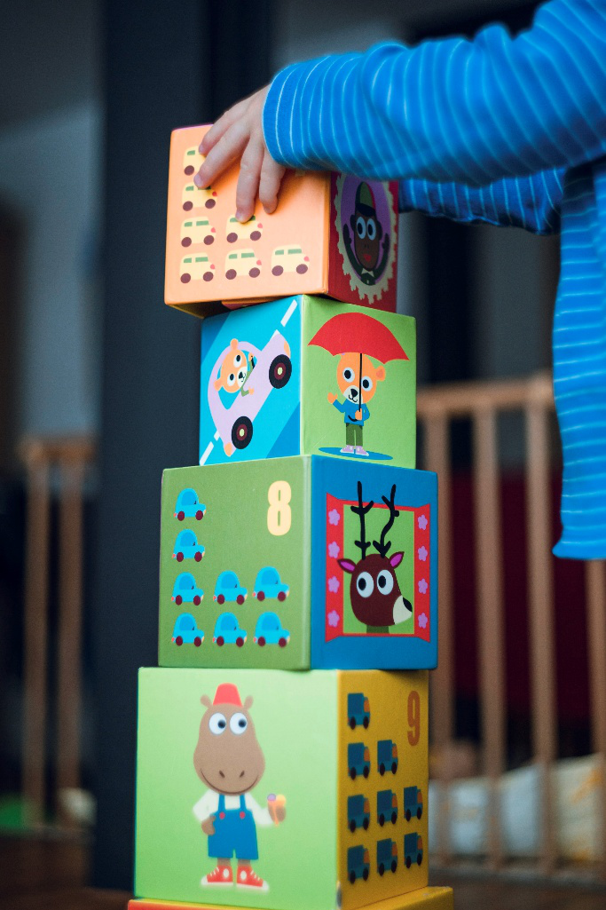 A child stacking blocks