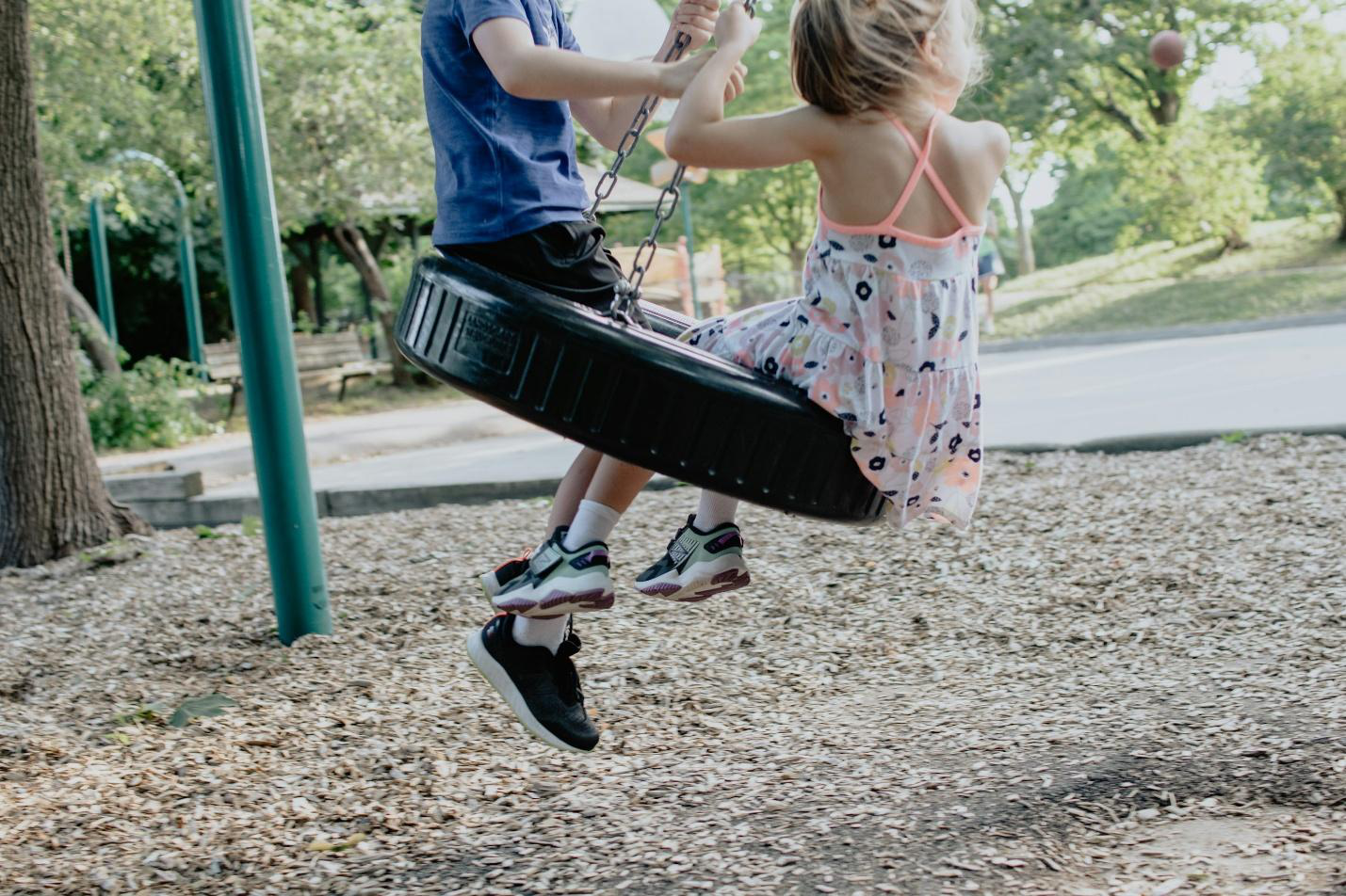A tyre swing with two children