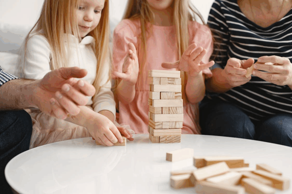 a family sitting together at the table playing Jenga