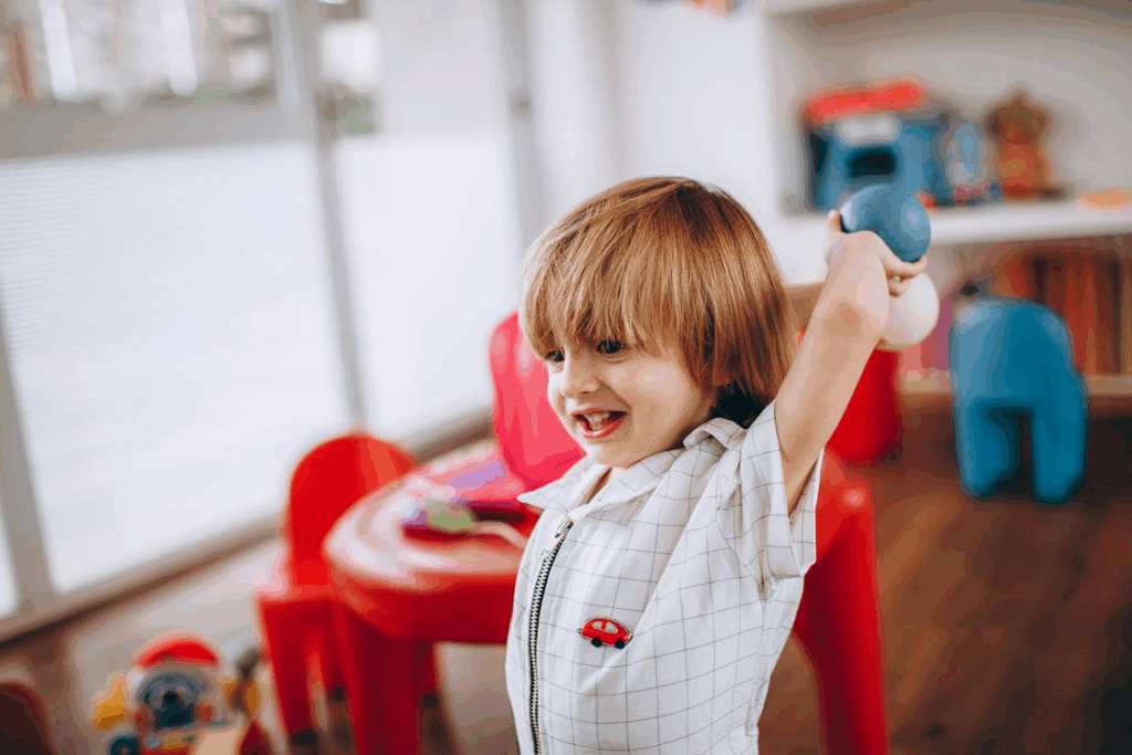 a child holding a blue ball