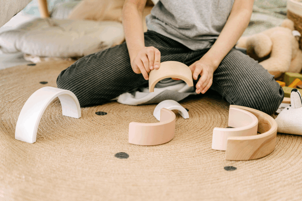 a child playing with wooden blocks
