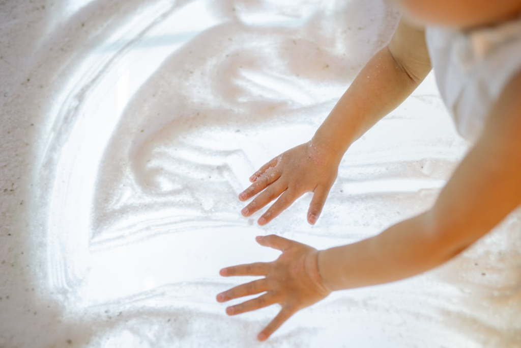 A child engaging in sensory play